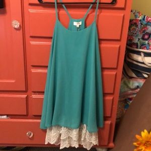 Flowy teal dress with lace around the bottom